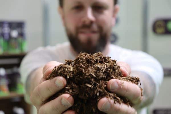 A close-up photograph showing PlantGrow Natural Soil Conditioner, Mulch & Fertiliser