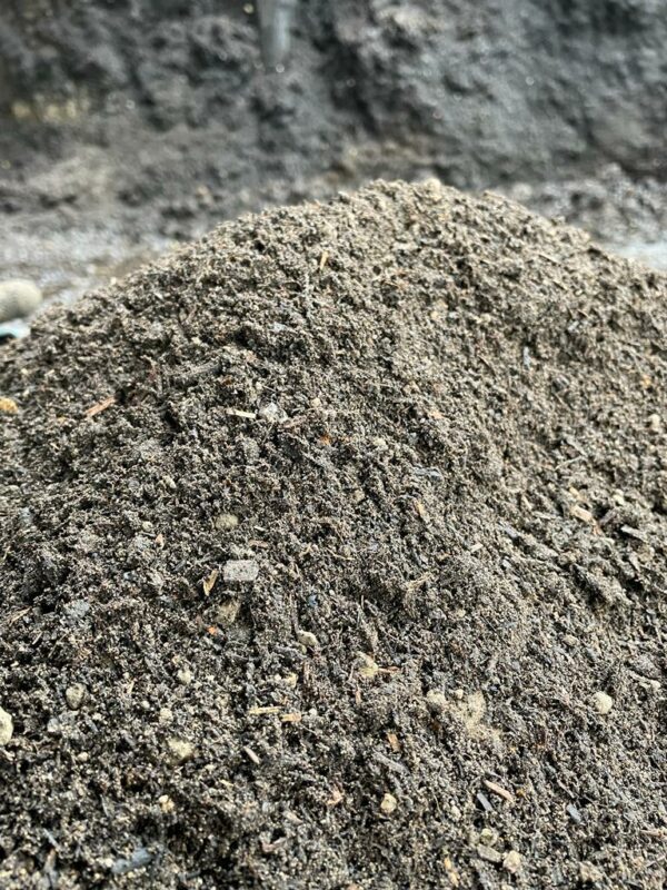 A photograph showing a mound of top soil, mulch and fertiliser mix