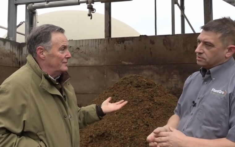 RHS judge Martin Fish discusses peat-free compost with PlantGrow representative at growing facility.