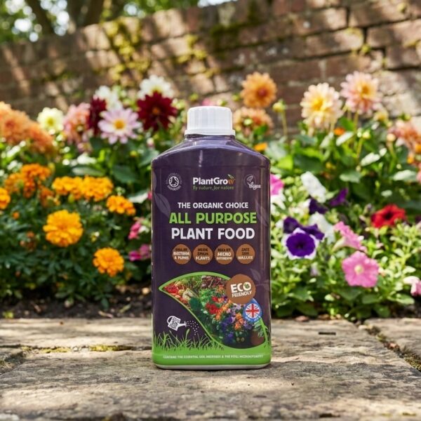 PlantGrow all purpose plant food bottle displayed on garden path with blooming flowers behind