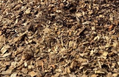 Decorative woodchip mulch showing screened, evenly-sized whole-tree wood pieces in natural brown tones.