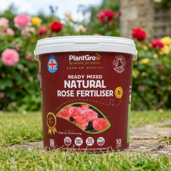 PlantGrow Ready Mixed Natural Rose Fertiliser, 10 litre tub, displayed in a garden setting with flowering roses behind.
