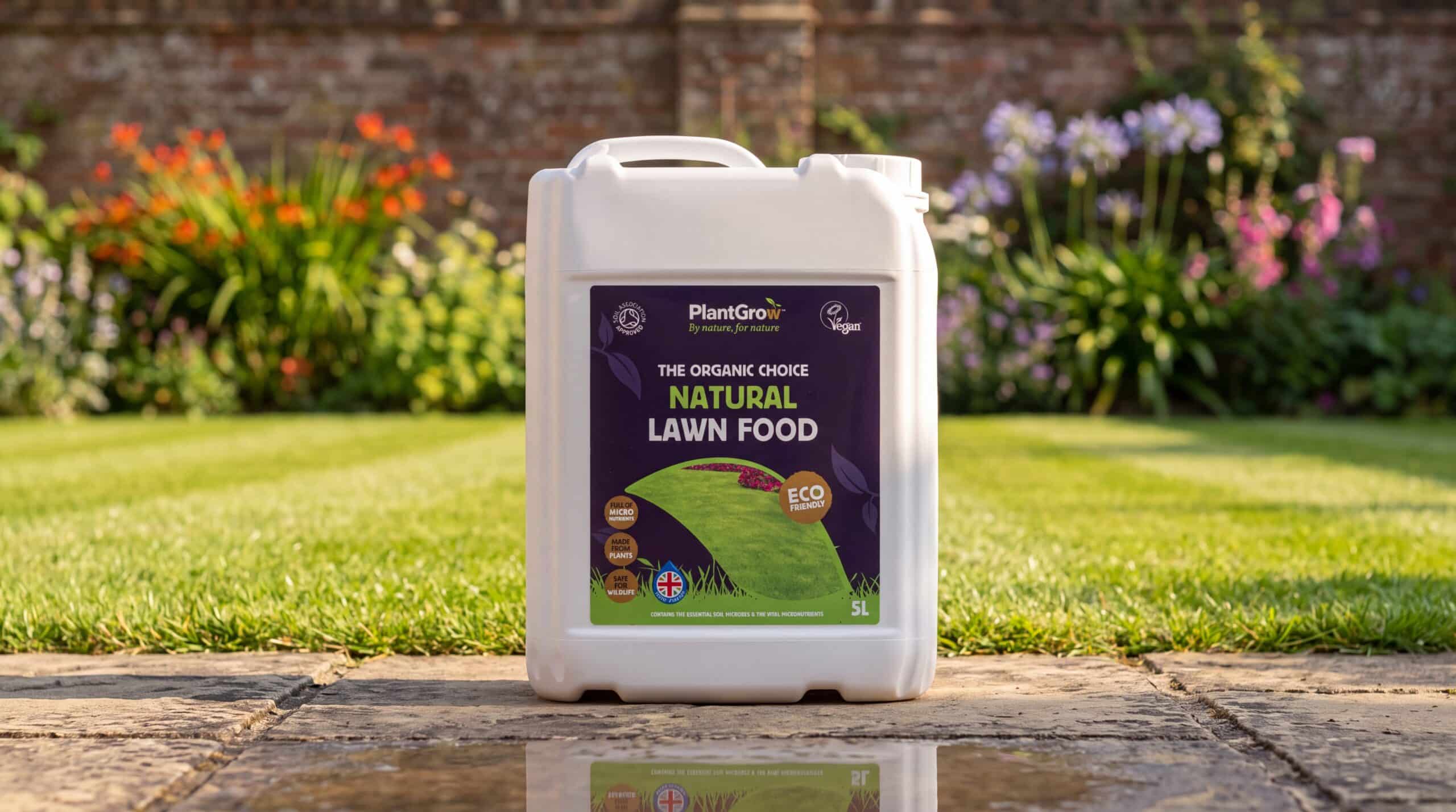 PlantGrow Natural Lawn Food 5L container positioned on paving with vibrant garden beds behind.
