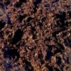 Close-up of natural fertiliser, showing organic plant-based material with dark and golden-brown tones.