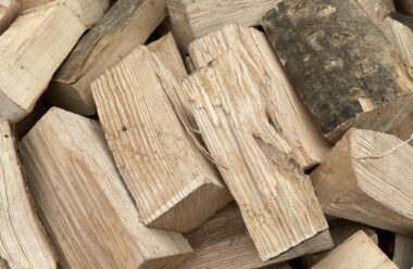 Kiln dried hardwood firewood chunks in white container, showing ash, sycamore and beech wood pieces.