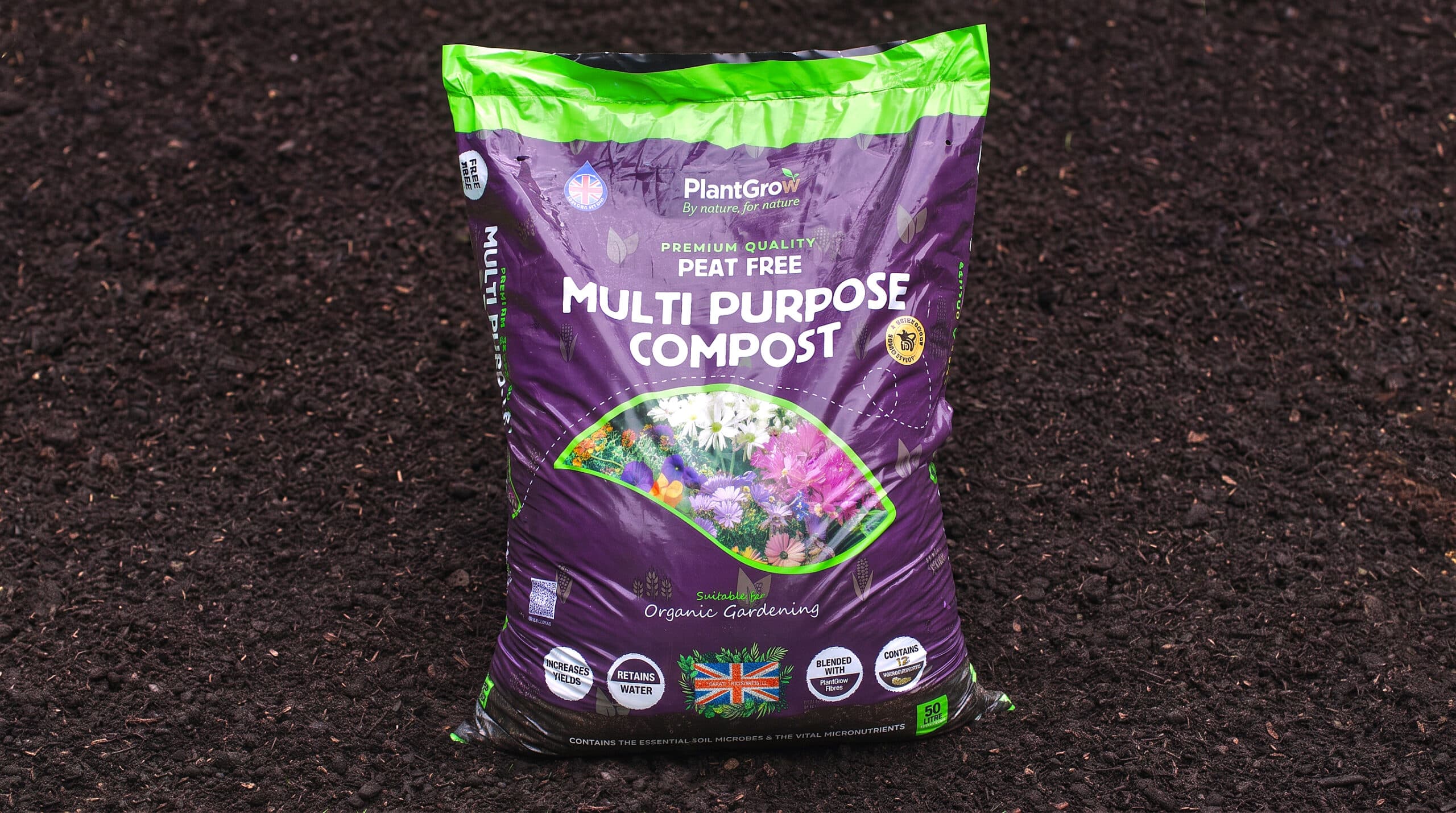 PlantGrow peat-free multi-purpose compost single bag with purple packaging on dark soil background.